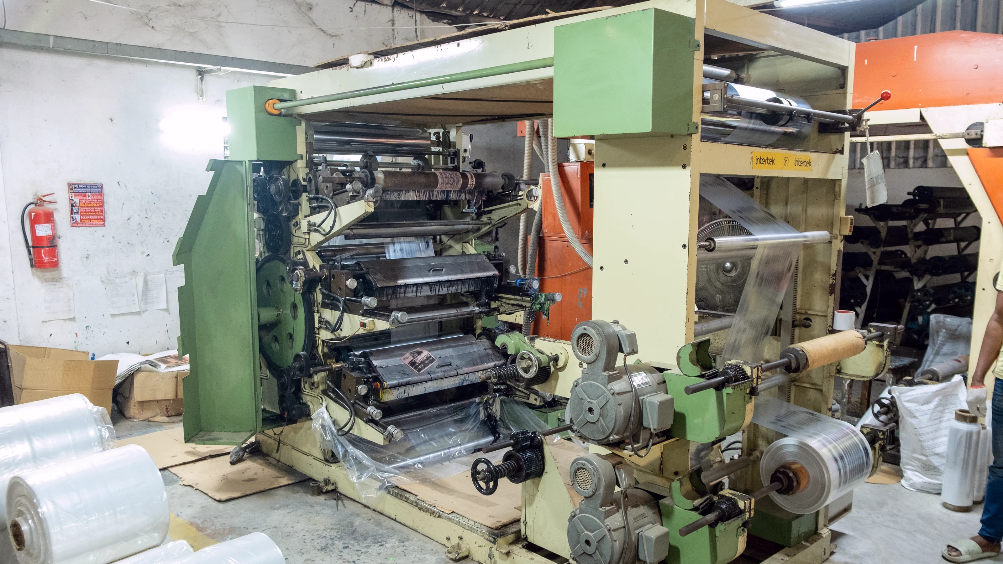 The poly and flexo printing line, with rolls of film stacked beside the press