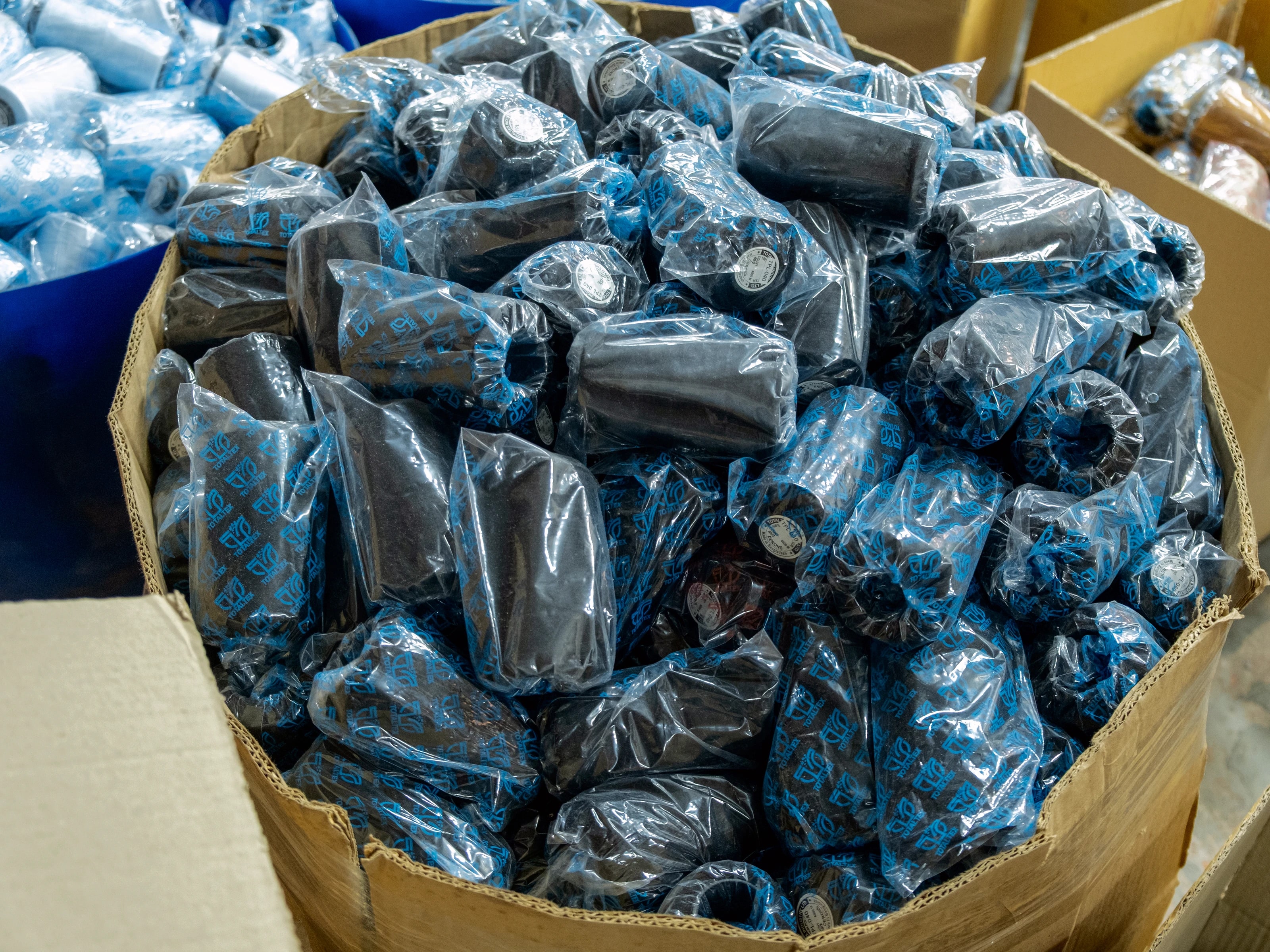 Bulk product packed in TotalTex-branded poly bags inside a round fibre drum