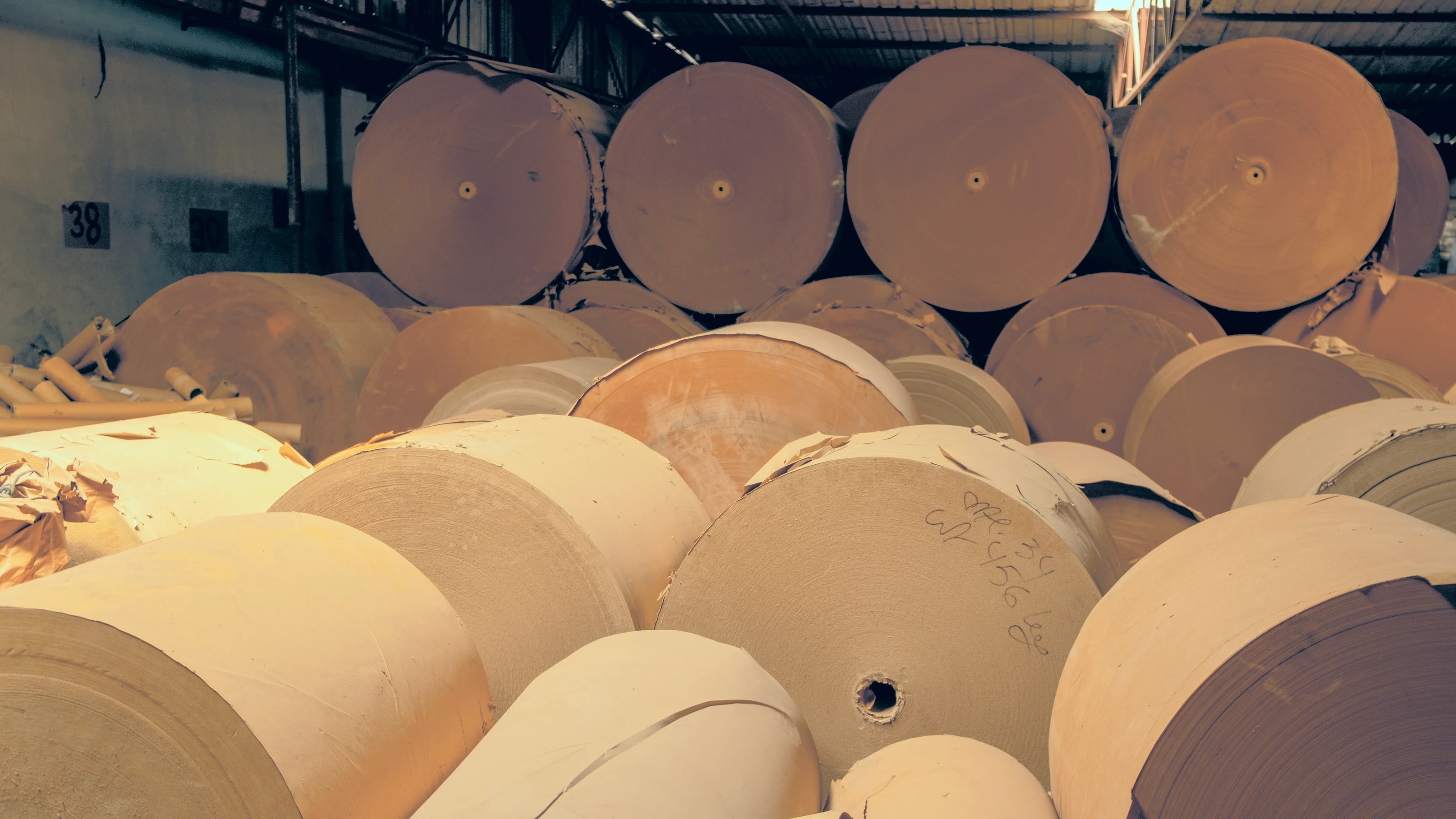 Stacked kraft paper roll stock in the materials warehouse