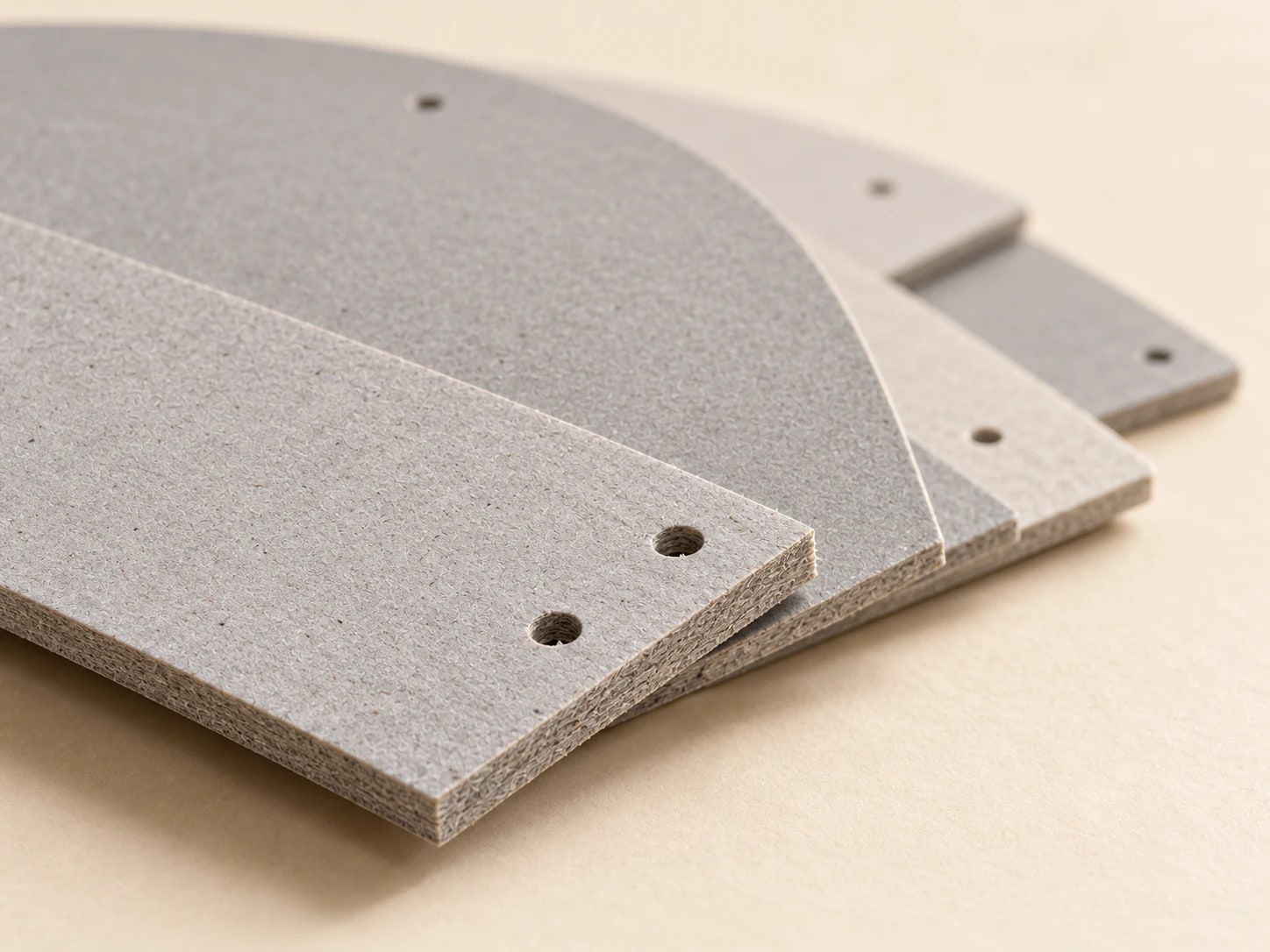 Close view of layered greyboard edges and punched holes