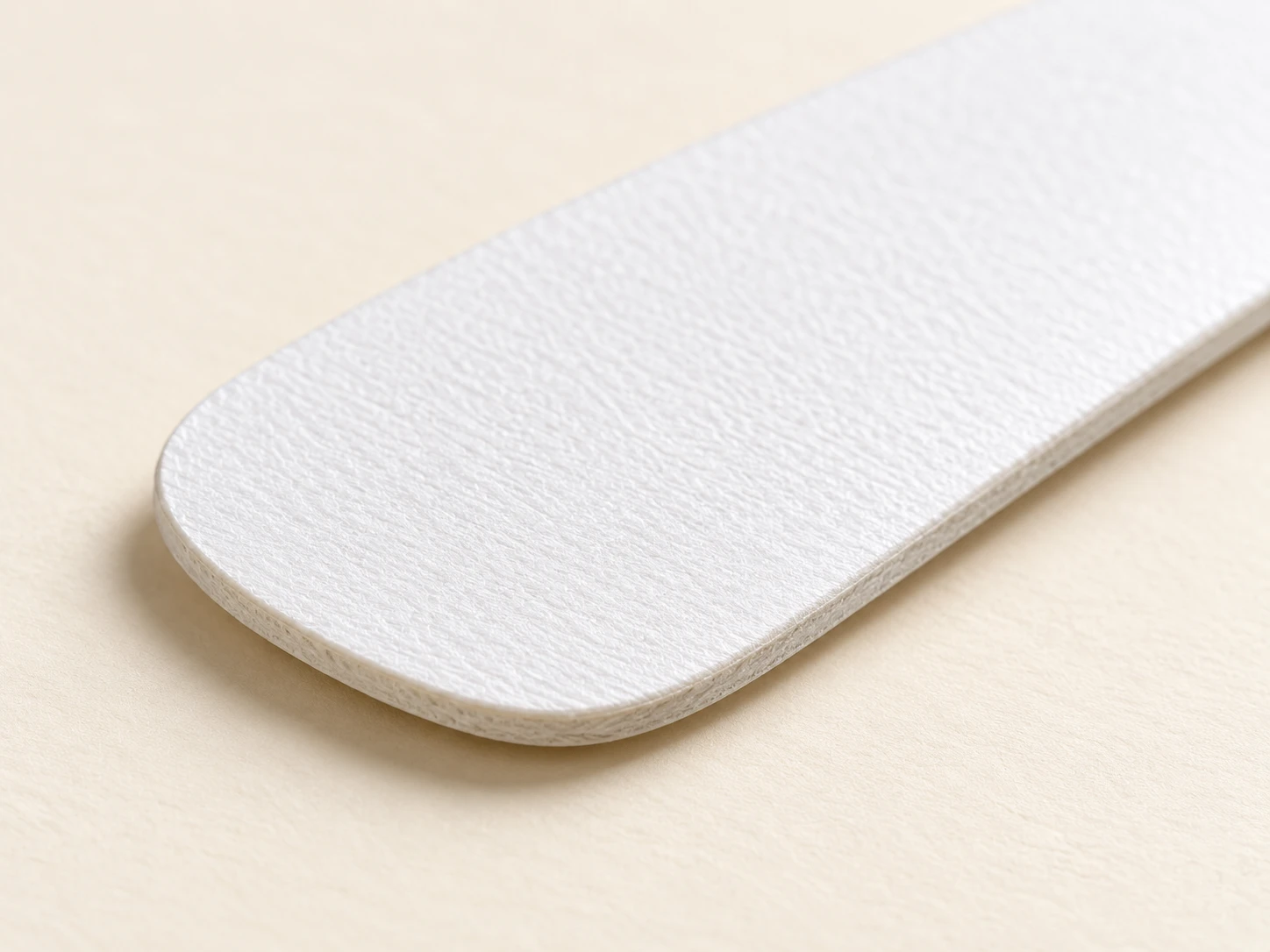 Close view of stacked white collar inserts and their edges