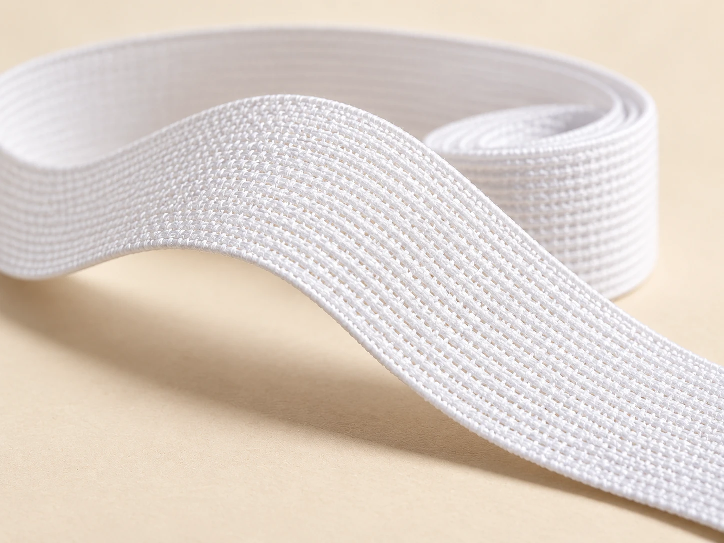 Close view of the knitted surface of white elastic